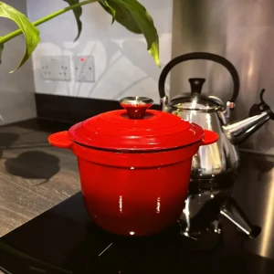Le Creuset Rice Cooker in cerise red on induction hob
