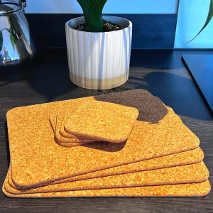 eco-friendly kitchen products - cork placemats and coasters on a table and plant pot in the background