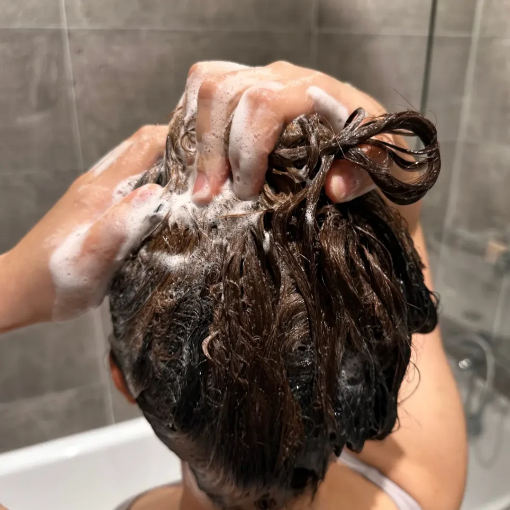 using Ethique shampoo bar - lather on hair