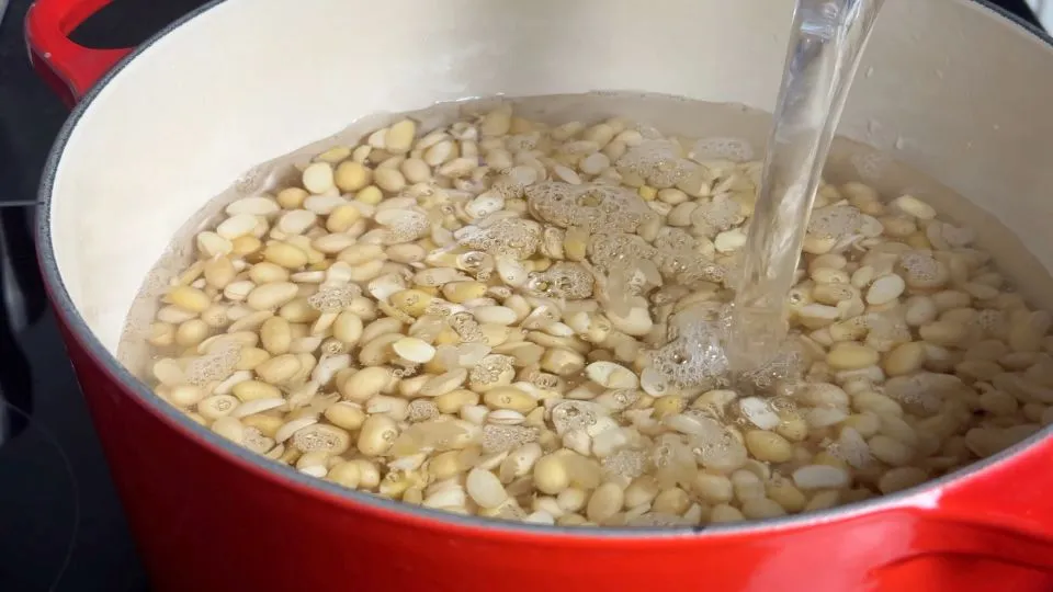 water poured in a pot full of beans