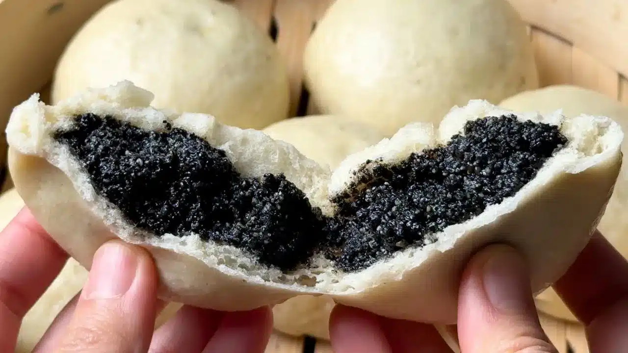 Black sesame steamed buns split open showing filling