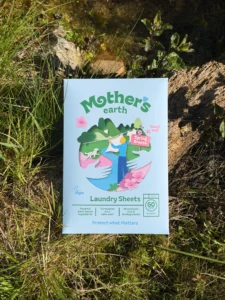 The front of a Mother's Earth Laundry Sheets box, Spring Breeze, 30 sheets, photographed on grass beside a mossy rock